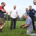 Prof John Gilliland examines a soil sample as part of the ArcZERO research project.