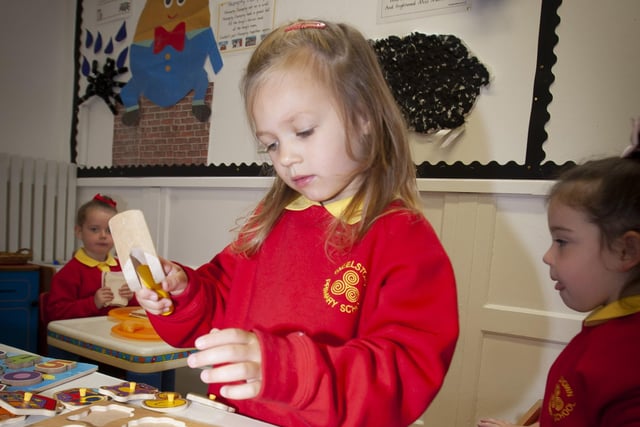 FITTING TO SIZE. . . . .P1 pupil Thora Hutton shows great concentration.
