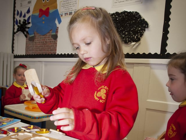 FITTING TO SIZE. . . . .P1 pupil Thora Hutton shows great concentration.
