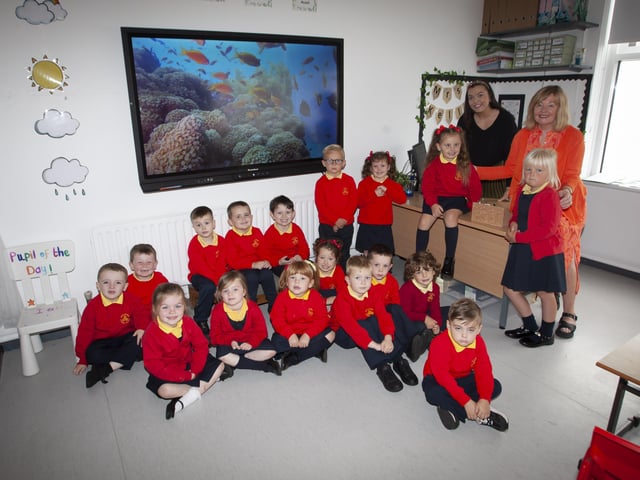 Miss Kelly with her P1 class at Steelstown Primary School. On right is Mrs. Siobhan Gillen, Principal. (Photos: Jim McCafferty Photography)