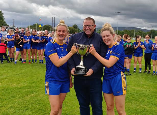 Joint Steelstown Ladies captains Ciara McGurk (left) and Aoife McGough receive the Derry Senior Championship trophy from Derry LGFA Chairperson, Sean Hamill after defeating Ballymaguigan in Glen on Sunday.
