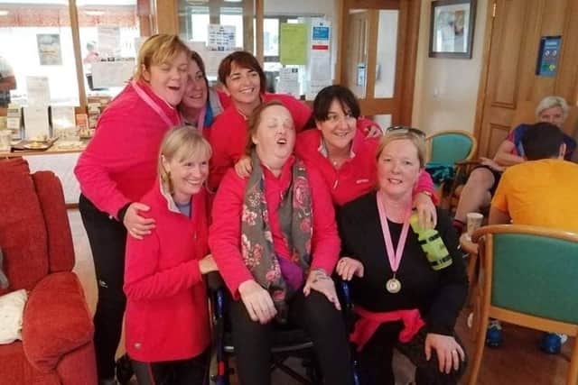The ‘No Frontiers’ ladies-only book club celebrate with a delighted Jacqui in Foyle Hospice in 2019, following their first Ladies Cycle