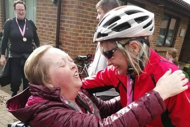 Jacqui congratulates her aunt, Anne, as she makes it over the finishing line outside Foyle Hospice after their first year completing the cycle in 2019
