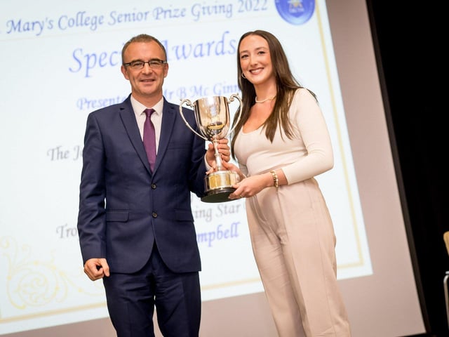 Mr Brendan Mc Ginn (Principal) Congratulating Cara Mc Guinness awarded The James Mc Cafferty Memorial Trophy for her outstanding contribution to Music
