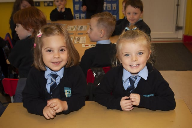 Hollybush PS P1 pupils Maria McNickle and Ava Temple smile for the camera.