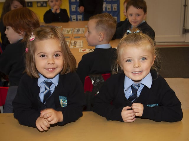 Hollybush PS P1 pupils Maria McNickle and Ava Temple smile for the camera.