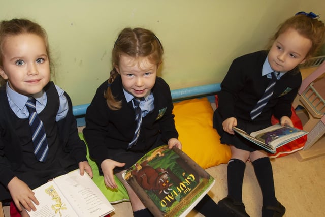 Ava Irvine-O'Donnell, Rosie Armstrong and Fiadh Galbraith enjoying some reading in Mrs. White's P1 class.