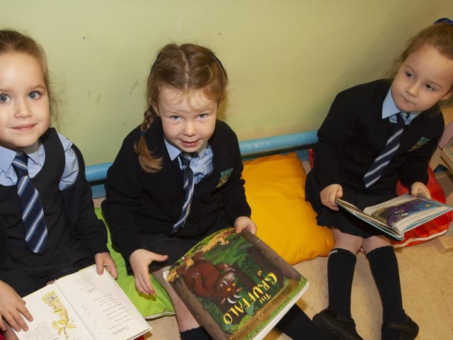 Ava Irvine-O'Donnell, Rosie Armstrong and Fiadh Galbraith enjoying some reading in Mrs. White's P1 class.