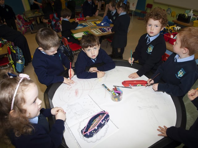 Some of the children in Mrs. White's P1 class enjoying drawing on Tuesday morning last.