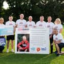 Kevin's wife, son and friends present a cheque to Alzheimer's Society volunteer Moira Shaw and Community Fundraiser Linzi Stewart.