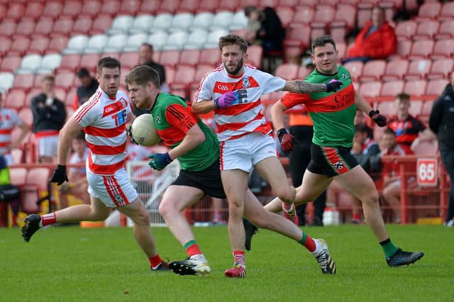 Doire Trasna’s Tom Casey evades a challenge from Ballerin pair Anton Bradley and Shane Ferris during the JFC Semi Final in Celtic Park on Sunday afternoon last. Photo: George Sweeney. DER2240GS – 007