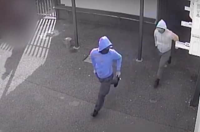 The two suspected gunmen leaving the Donegal Celtic social club on Sunday.