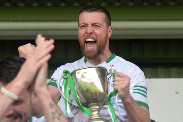 Craigbane captain Brian Rainey lifts the Derry Junior Championship trophy after their win over Ballerin at Celtic Park on Sunday afternoon. (Photo: George Sweeney)