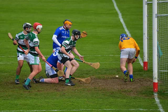 Warrenpoint's keeper Anthony O'Brien makes a goal line clearance from a shot by Na Magha's Keelan Doherty. (Photo: George Sweeney)