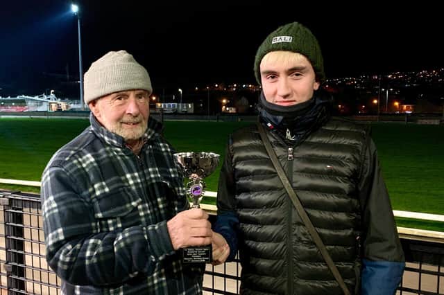 Robert Montgomery (left) represented the sponsors Vincent McGuinness & Juliet Aldridge on Monday when presenting the Rosehill Kennels Trophy to Liam Carlin after Kearneys Galaxy was voted out favourite performer on 7/11/22.