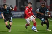 Larne's Ben Doherty skips away from Linfield duo Stephen Fallon and Christy Manzinga, during last season's encounter at Inver Park. Picture by Stephen Hamilton/INPHO