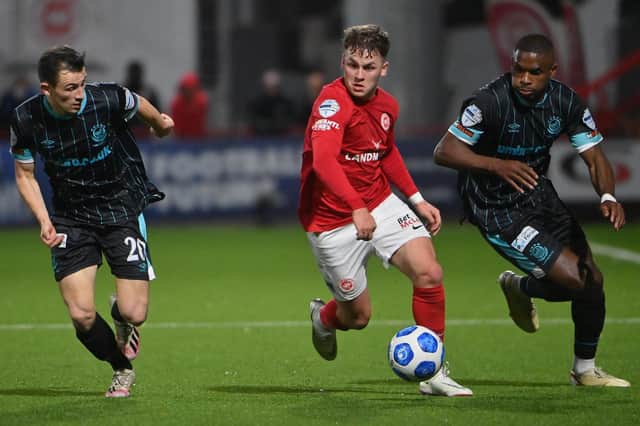 Larne's Ben Doherty skips away from Linfield duo Stephen Fallon and Christy Manzinga, during last season's encounter at Inver Park. Picture by Stephen Hamilton/INPHO