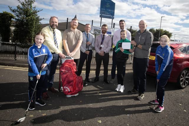 Pictured at Hollybush PS on Monday morning are Mr. Feargal Friel, Principal, presenting Bryan McBay with his prize for winning the Hollybush Golf Classic at Foyle Golf Club on Saturday last. On right, Mr. Andy McDermott, School Building Supervisor, presenting Mary-Jo Cassidy with the first prize in the Grand Prize Draw. The events were held to raise funds for the school's new Outdoor Play Area. Included from left are Sophia Burke, Mr. Francis Mallon, Mr. Matt McNulty, teachers, Mr. Cahir O'Connor, Vice Principal and Alexandra Houston. (Photos: Jim McCafferty Photography)