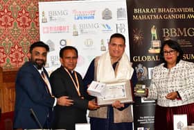 Dr. Mukesh Chugh receiving a prestigious BB-Mahatma Gandhi Award 2024, from the Honourable Health Minister of Uttarakhand, India, Dr. Dhan Singh Rawat, Dr. Hans, and Baroness Sandip Verma.
