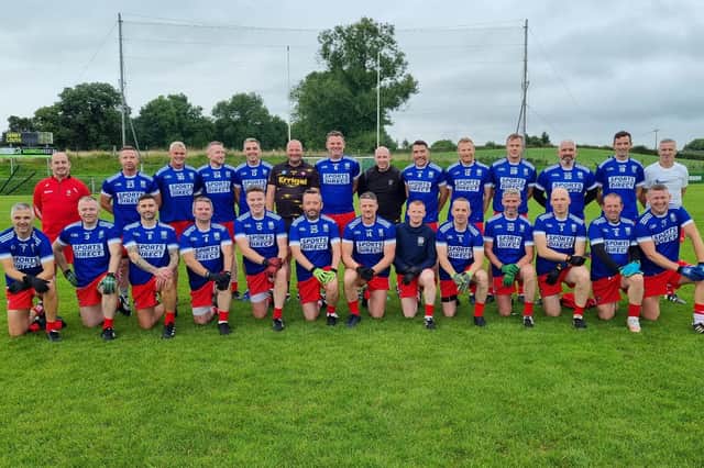 The Derry Masters squad, sporting Bellaghy jerseys, line out before their weekend game against Louth.