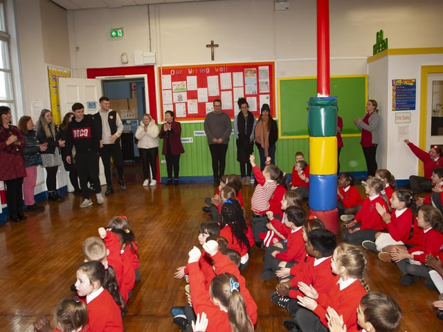 Derry City duo Declan Glass and Cameron McJannet receive a rapturous reception on their arrival at St. Eugene’s PS on Tuesday afternoon.