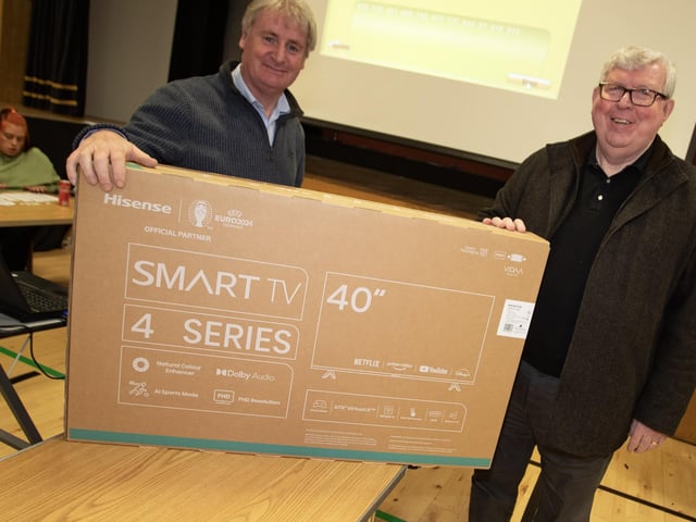 St. Joseph's Boys School Vice Principal Mr. Paul Kealey presenting one of the main prizes of Thurday's Wheel of Fortune to winner, Mr. Eugene Gallagher.