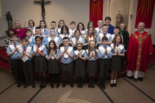 Pupils from Mrs. Jennifer Gallagher’s class at St. Brigid’s Primary School who received the Sacrament of Confirmation from Fr. John Farren at St. Brigid’s Church, Carnhill on Wednesday afternoon last. Included is Principal Ms. Mary McCallion and Classroom Assistants Mrs. Iona Wiley and Miss Tia Finnis. (Photo: Jim McCafferty Photography)