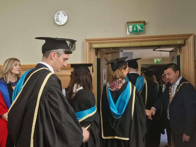Graduates are congratulated by the Mayor of Derry & Strabane, Councillor Ruairí McHugh, as they make their way from the Council chamber to the Main Hall in the Guildhall to complete their graduation. Also pictured is Professor Patricia Harris, Course Director for Ulster University's Graduate Entry Medical School.