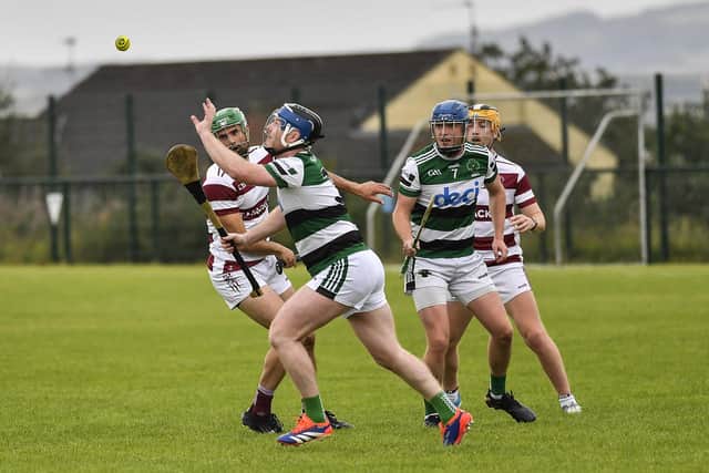 Na Magha’s Diamuid Shiels gets the sliothar ahead of Slaughtneil’s Chrissy Mc Kaigue. Photo: George Sweeney
