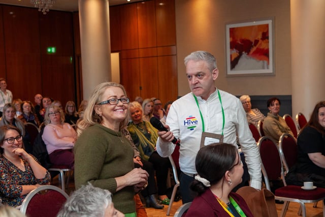 Hive Cancer Support member Marguerite Burke addressing a question to the panel of experts at the conference.