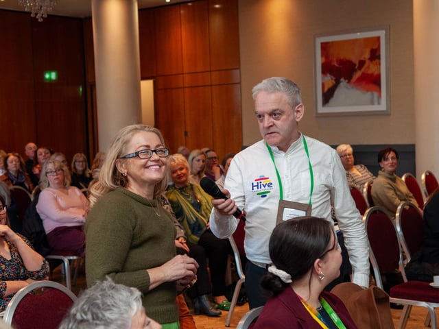 Hive Cancer Support member Marguerite Burke addressing a question to the panel of experts at the conference.