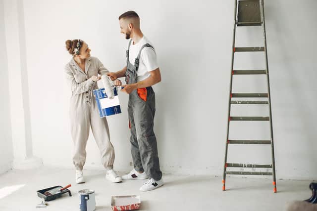Couple preps for a weekend DIY paint makeover, turning their blank wall into a fresh new canvas.