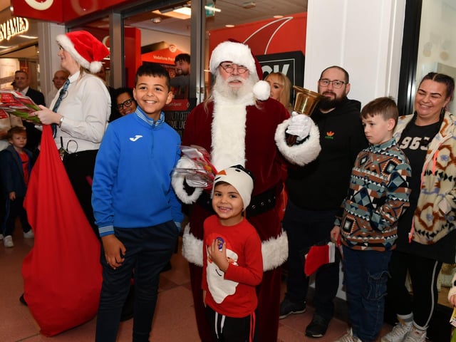 Brothers Darragh and Myles Keogh pictured with Santa in the Richmond Shopping Centre on Saturday morning. Photo: George Sweeney