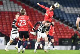 Derry City target Dominic Thomas (Queens Park) is outjumped for this high ball by Falkirk's Dylan Tait at Hampden Park.