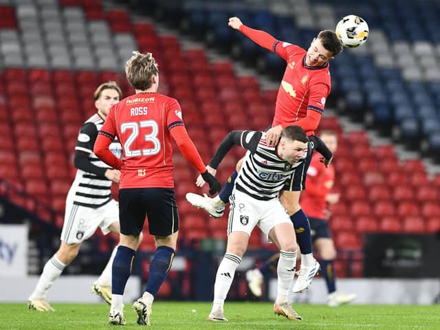 Derry City target Dominic Thomas (Queens Park) is outjumped for this high ball by Falkirk's Dylan Tait at Hampden Park.