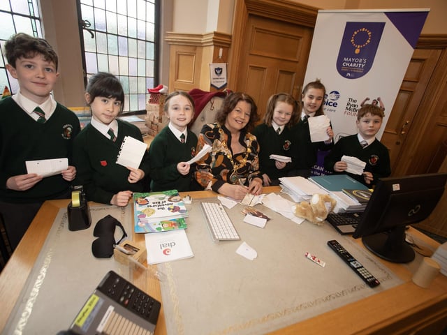 Pupils from Greenhaw PS take time out to get the Mayor's autograph during a visit to the Guildhall. (Photo: Jim McCafferty Photography)