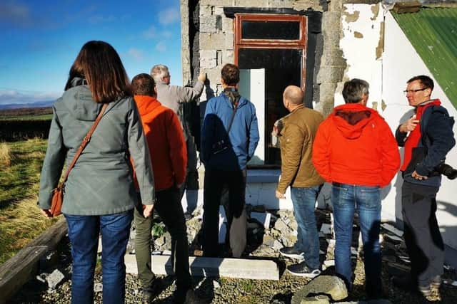 International experts, who research the impacts of deleterious minerals, examine another house in Inch Island on Wednesday.