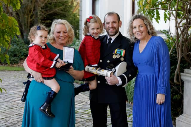 Kevin Barr with on left Geraldine Mullen (the lady who he saved) and on right his wife Grace Barr and their children Tess age 4 and Kate age 2 after he received a Gold medal at the Oireachtas National Bravery awards.  Pic Maxwell’s .
