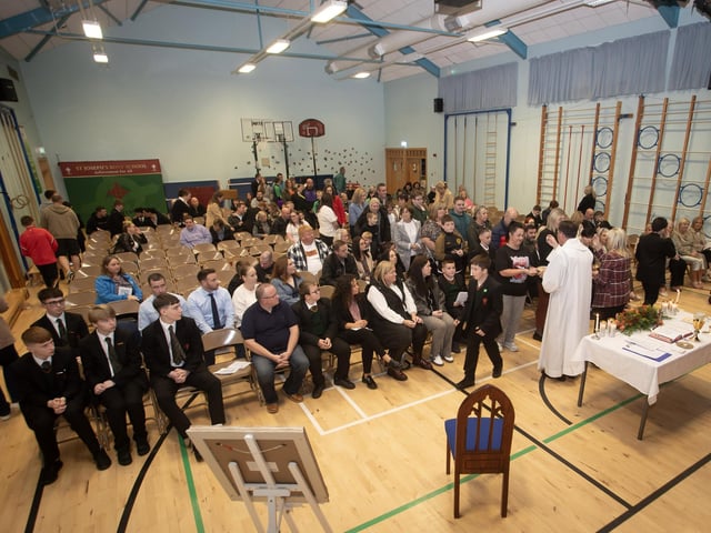 Staff, students and parents receiving First Holy Communion at Thursday evening's Mass in St. Joseph's Boys School.
