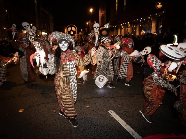 Cheerful dancers make their way up Strand Road.