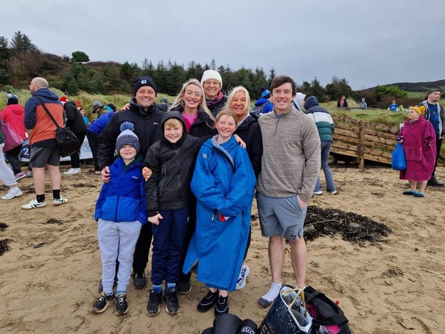 Young Rosie Roddy from Derry (front in blue coat), who has raised £700 for the Foyle Hospice, pictured with family members at the annual Christmas Day swim.