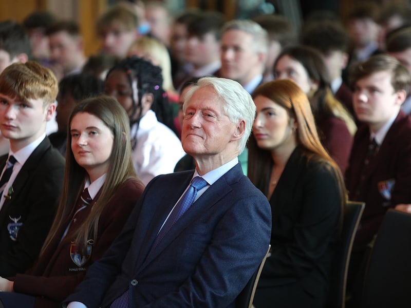 Bill Clinton seated alongside Ellianna McBride and James Tourish, who also spoke at the event.