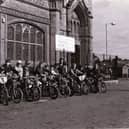 Young cyclists on BMX bikes outside Derry's Guildhall.