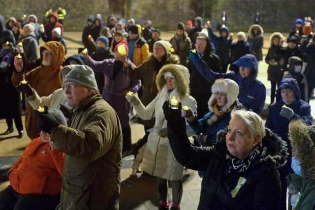 People gather in Guildhall Square in March 2022  during a candle-lit vigil in solidarity with the people of Ukraine. Photo: George Sweeney. DER2209GS – 034