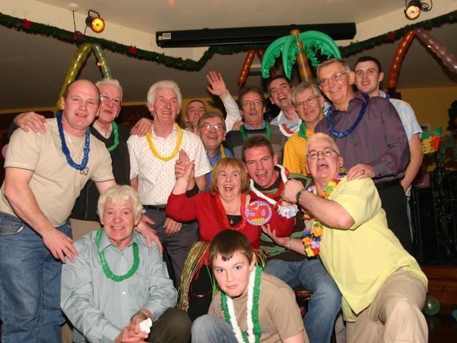 Ann Lindsay surrounded by men at her 50th Party in the Argyle Arms . 1205 /dd : Parties in December 2005.