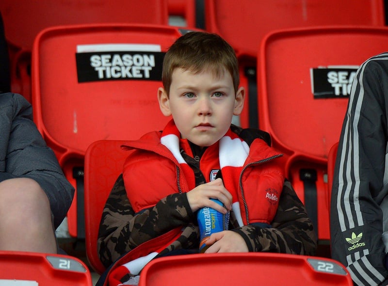 This young Derry City fan is patiently waiting for the game against Finn Harps to start. Photo: George Sweeney. DER2305GS – 08