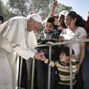 Pope Francis meets migrants at the Moria detention centre on April 16, 2016 in Mytilene, Lesbos, Greece. (Photo by Andrea Bonetti/Greek Prime Minister's Office via Getty Images)