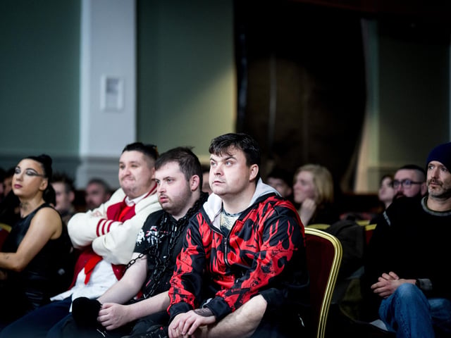 Audience members watch on intently.