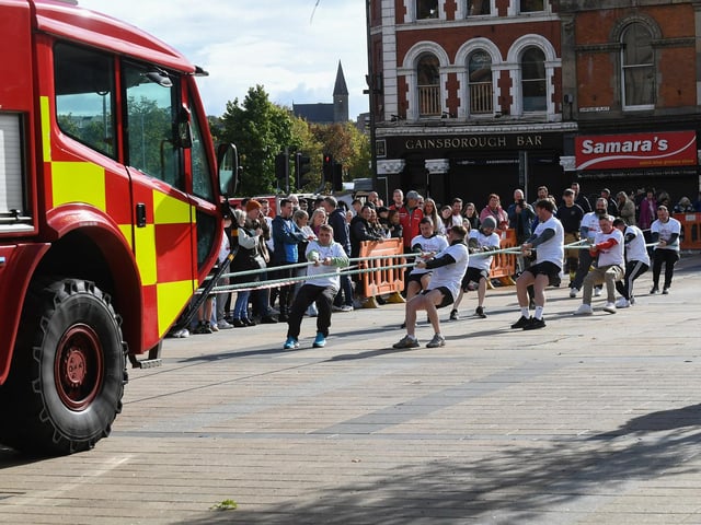 One of the fundraising teams pulls a 32-tonne City of Derry Airport Fire and Rescue Engine, in Guildhall Square, in aid of Children In Crossfire. Photo: George Sweeney