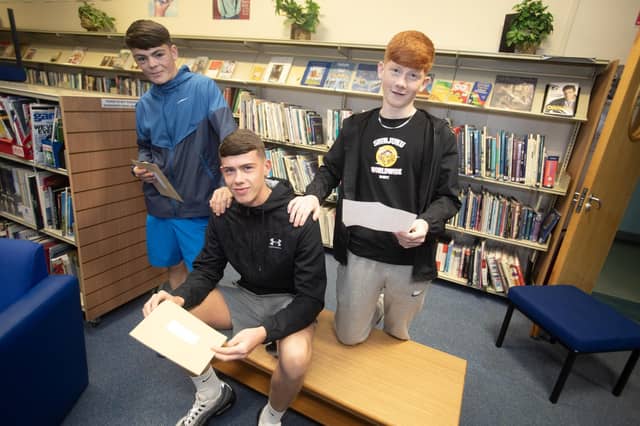 St. Joseph's GCSE students Cormac McDaid, Niall O'Kane and Liam Campbell check out their results on Thursday. (Photos: Jim McCafferty Photography)